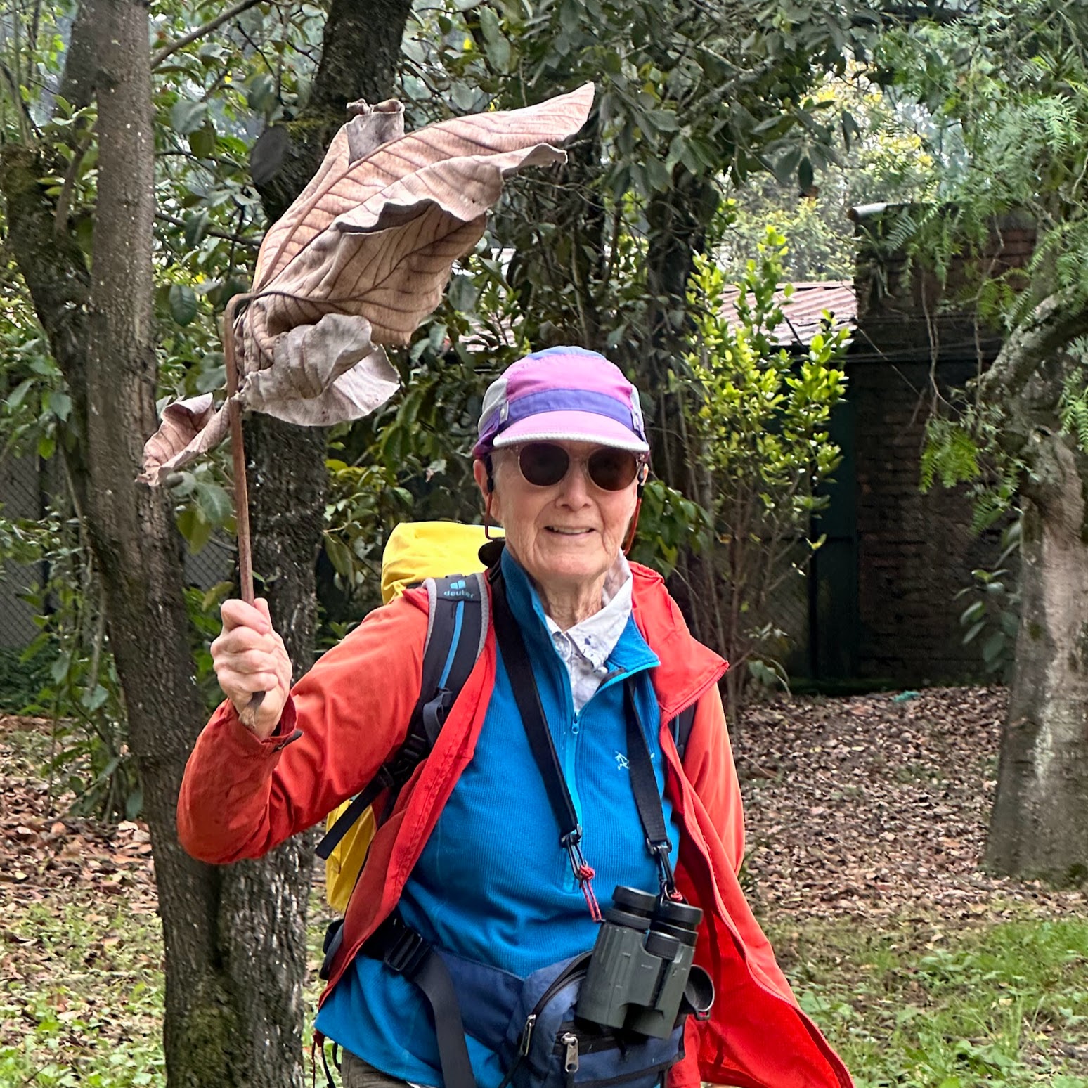 Lisa Baile - Medical researcher and wilderness education advocate in outdoor gear with binoculars