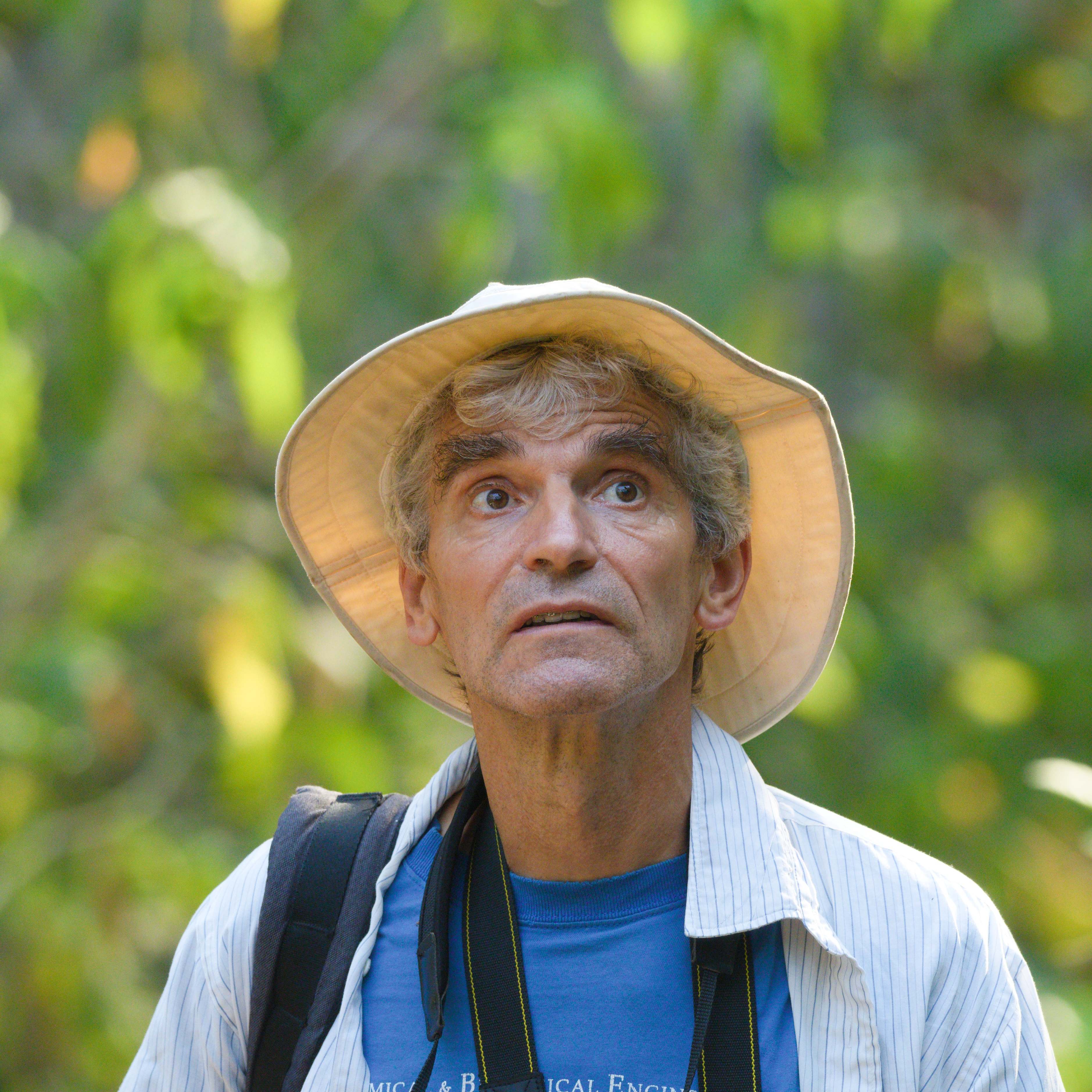 Sylvain Alie - Board chairperson wearing a wide-brimmed hat and binoculars in natural setting